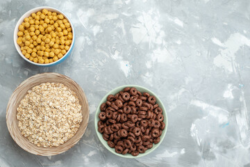 top view chocolate cereals inside green plate on the blue background with yellow cereals cacao breakfast food cereals health