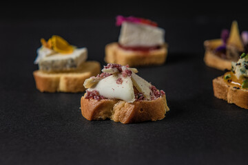 focus on various gastronomic appetizers on a black background