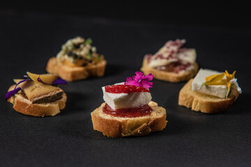 focus on various gastronomic appetizers on a black background