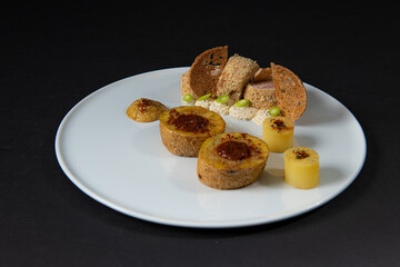 Gourmet and gastronomic chicken dish with potatoes isolated on a black background
