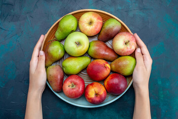 top view fresh mellow fruits pears and apples inside plate on the dark-blue desk fruit fresh ripe mellow vitamine - obrazy, fototapety, plakaty