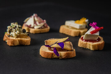 focus on various gastronomic appetizers on a black background