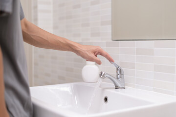 Save water. Volunteer keeps turning off the running water in the bathroom to protect environment....