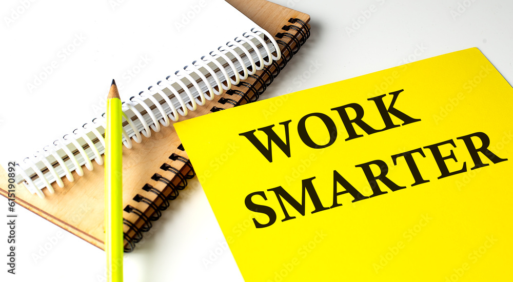 Poster work smarter text written on a yellow paper with notebook