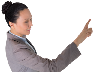 Digital png photo of smiling asian businesswoman pointing with finger on transparent background
