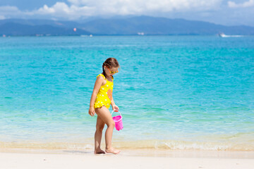 Fototapeta premium Kids play on tropical beach. Sand and water toy.