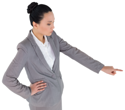 Digital png photo of serious asian businesswoman pointing with finger on transparent background
