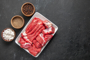 top view fresh sliced meat with seasonings on a dark background meat butcher barbecue meal dinner animal food