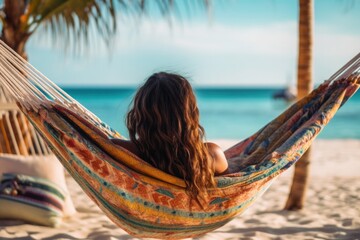 Traveler woman relax in hammock on summer beach Thailand, no face shown, back view, sunny summer day