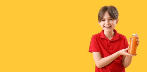 Little boy with bottle of juice on orange background with space for text