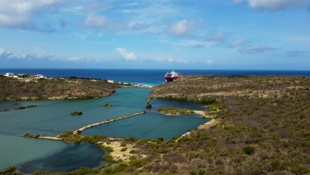 Caribbean Sea coast with an oil rig platform blue water ocean. Flying drone arial shot rocky and sandy beaches and beautiful waves. Perfect holiday travel exotic destination Curacao Aruba Bonaire