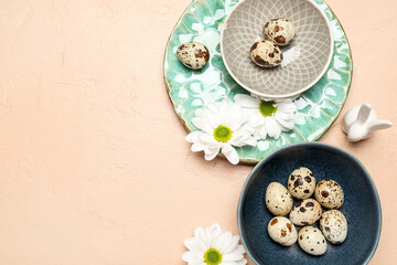 Fototapeta na wymiar Composition with Easter quail eggs, chamomile flowers and bunny on beige background