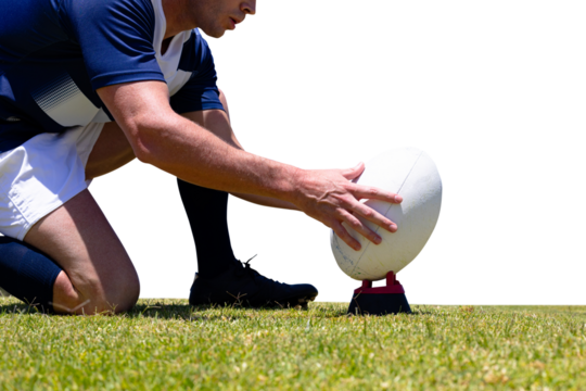 Digital png photo of caucasian rugby player putting down ball on transparent background