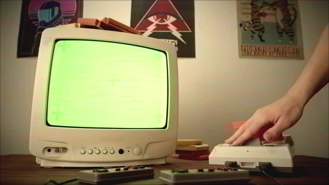 Vintage tv chroma key green screen with Old TV Game Console with ROM Cartridge with TV, Vintage Gamer Room Joystick and Retro TV, Man Player Start the Game, Play.
