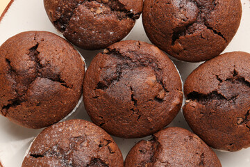 Tasty chocolate cupcakes on plate, closeup