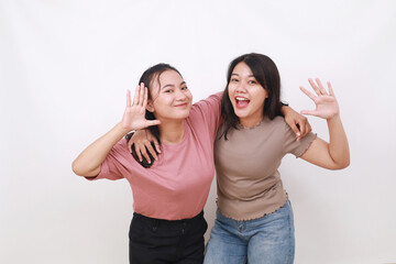 Two young cheerful Asian women on white background