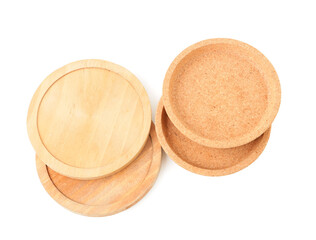 Wooden kitchen boards and cork plates on white background