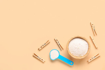 Laundry detergents and clothespins on beige background