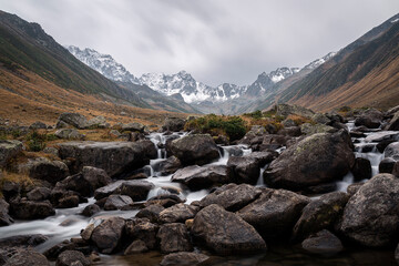 snowy Kaçkar mountains and stream flowing through rocks. Rize