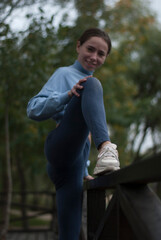 View of a girl with athletic body in the park