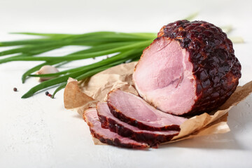 Tasty smoked ham on light background