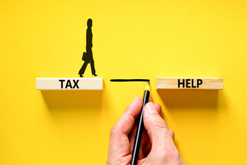Tax help symbol. Concept words Tax help on wooden blocks on a beautiful yellow table yellow...