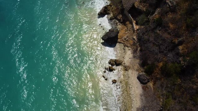 Sunny Caribbean Sea coast with tropical blue water ocean landscape. Flying drone arial shot rocky and sandy beaches and beautiful waves. Perfect holiday travel exotic destination Curacao Aruba Bonaire