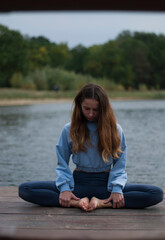 View of young girl is doing yoga outdoors