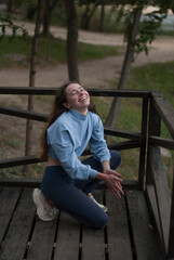 Fototapeta premium View on a girl smilling while doing acrobatics exercises in cloudy weather