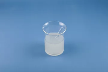 Fotobehang Solution of Xanthan Gum in glass flask. Food additive E415. Used in food industry, medicine, cosmetics, beauty products, hair products as binding agent. Natural Thickener gluten-free dood © AB-7272