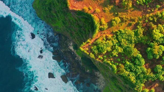 Travel people enjoy breathtaking view at Karang Boma Cliff Bali on background ocean waves crashing on the tropical beach Bali Indonesia 4K Aerial view