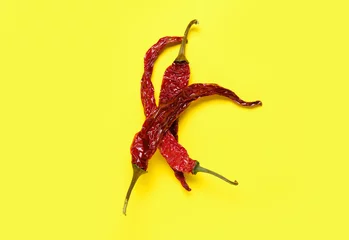 Keuken spatwand met foto Dry hot chili peppers on yellow background © Pixel-Shot