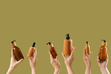 Hands holding different cosmetic products on color background