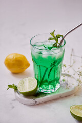 Non alcoholic healthy detox lemon, lime green sparkling cocktail. Vitaminized healthy drink.
