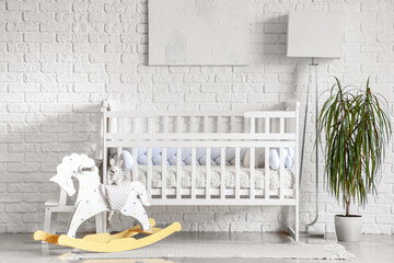 Interior of light bedroom with baby crib, toys and lamp - obrazy, fototapety, plakaty