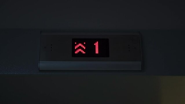 Display of an elevator going up indicating the floor number passing with red arrows. Concept. LED screen, interior.