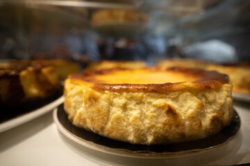Fototapeta premium Homemade basque style cheesecake in closeup with blurred background