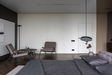 cool expensive interior design of room in prestigious luxury hotel with dark tones with modern LED lighting and stylish furniture. the area with a sink is separated by dark glass from the bedroom