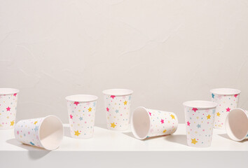 Paper cups with picture stars for cocktails and other holiday drinks on the table. Copy space for text.