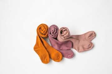 Children's multi-colored socks. Children's fashion, children's wardrobe, children's clothing. White background, top view.