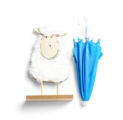 Creative composition with wooden toy sheep and mini umbrella on white background