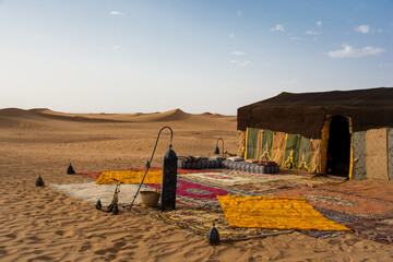 Traditional camping in the Sahara. Berber mobile home with carpet on the sand