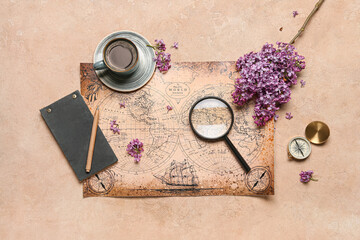 World map with cup of coffee, compass and magnifier on beige grunge background