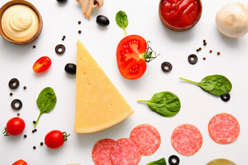 Fresh ingredients for preparing pizza on white background