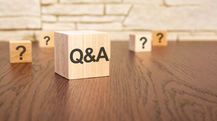 wooden blocks with text q and a on wooden table, close up. space for text