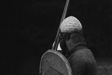 Side portrait of reenactor who act like viking warrior from early middle ages. - obrazy, fototapety, plakaty