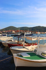 Fototapeta na wymiar Small fishing boat and picturesque skyline in Vela Luka, island Korcula, Croatia.