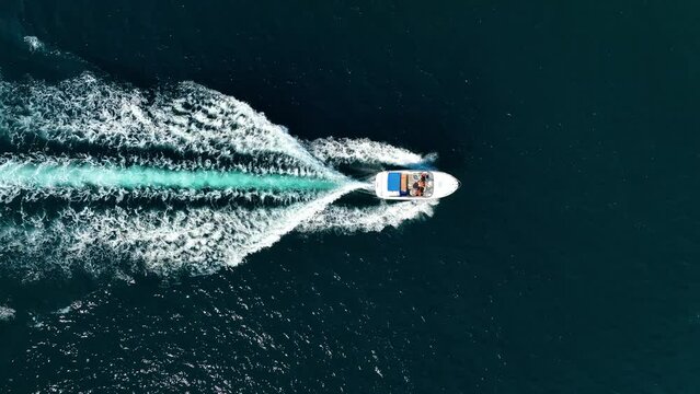 Vacation and leisure. Aerial view on fast boat on blue Mediterranean sea at sunny day. Fast ship on the sea surface. Seascape from the drone. Seascape from air. Seascape with motorboat.
