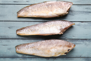 Raw codfish on green wooden background