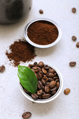 Bowl with coffee beans on light background